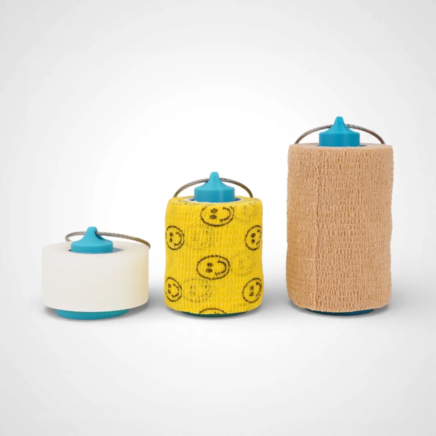 Blue roll holders made with polylactic acid created using additive manufacturing for holding tape and bandage rolls. In three sizes, 1 inch, 2 inch and 3 inch. With a steel cable keyring. All three sizes shown with tape on them on white background.