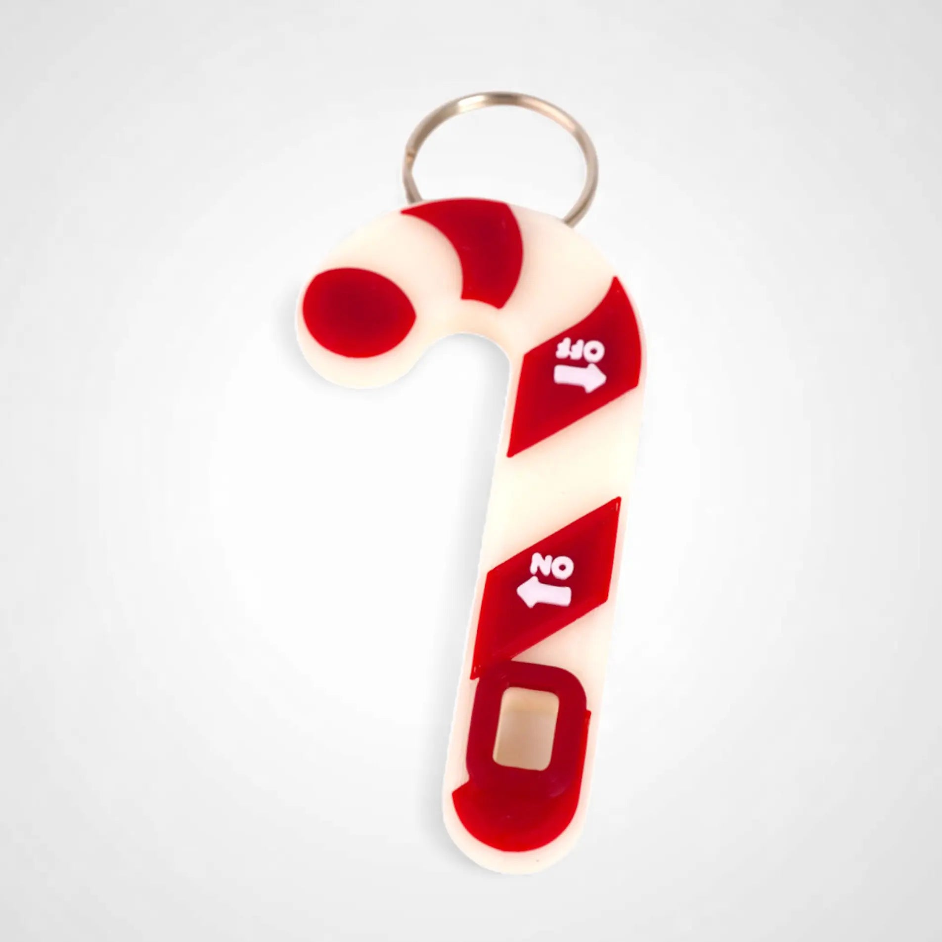 Candy cane-shaped keychain with red and white design on a light gray background
