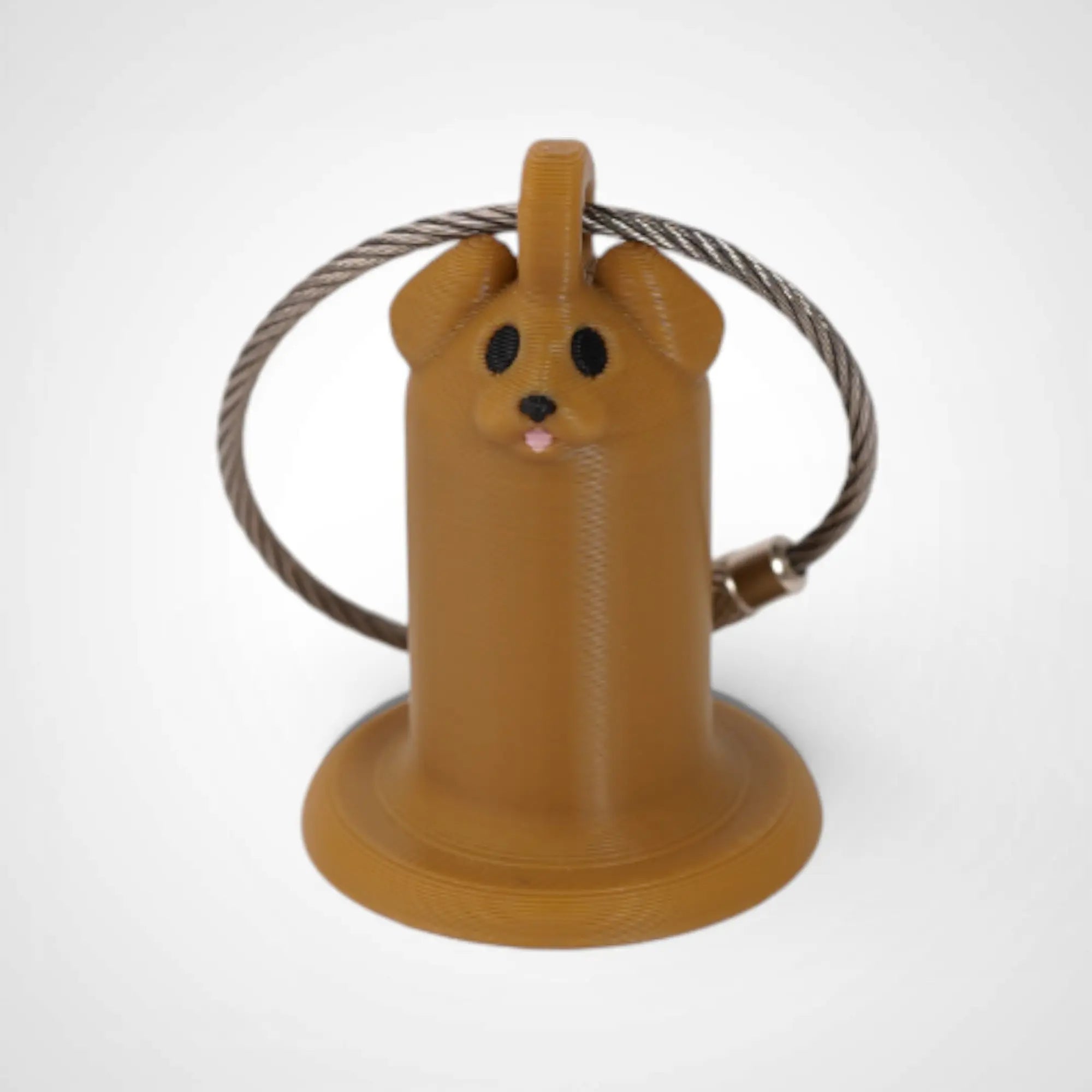 Brown Dog 1-inch roll holder made with polylactic acid, created using additive manufacturing for holding tape and bandage rolls. With a steel cable keyring. Shown on white background.