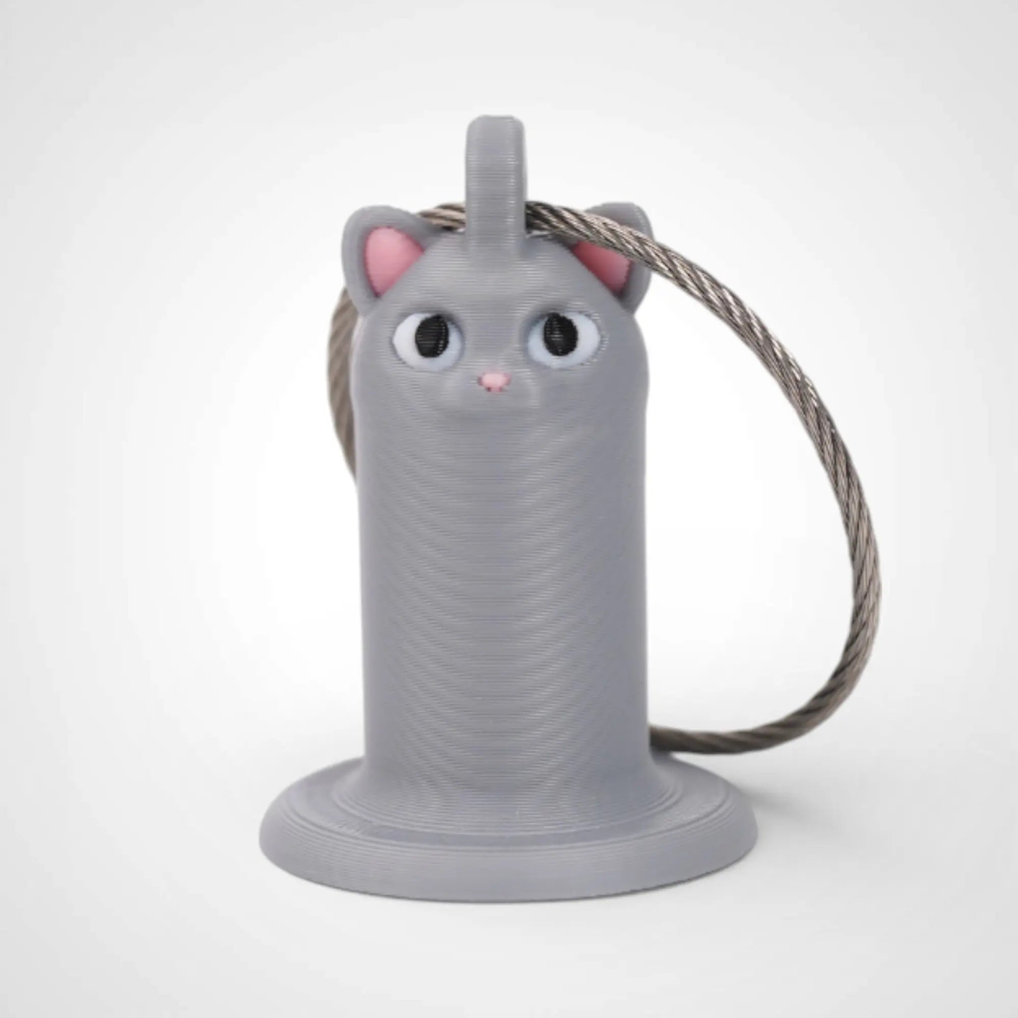Cat Grey 1-inch roll holder made with polylactic acid, created using additive manufacturing for holding tape and bandage rolls. With a steel cable keyring. Shown on white background.