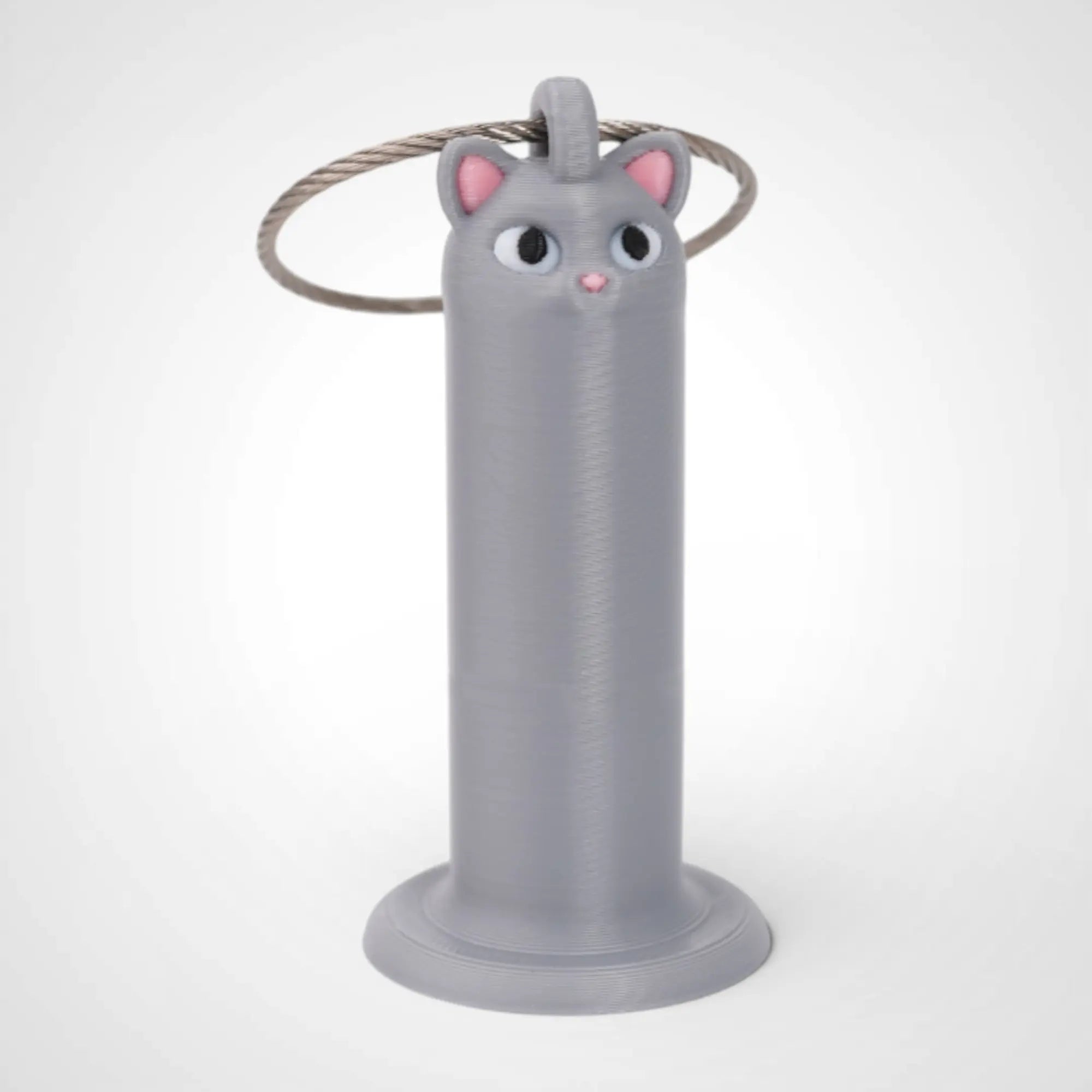 Cat Grey 2-inch roll holder made with polylactic acid, created using additive manufacturing for holding tape and bandage rolls. With a steel cable keyring. Shown on white background.
