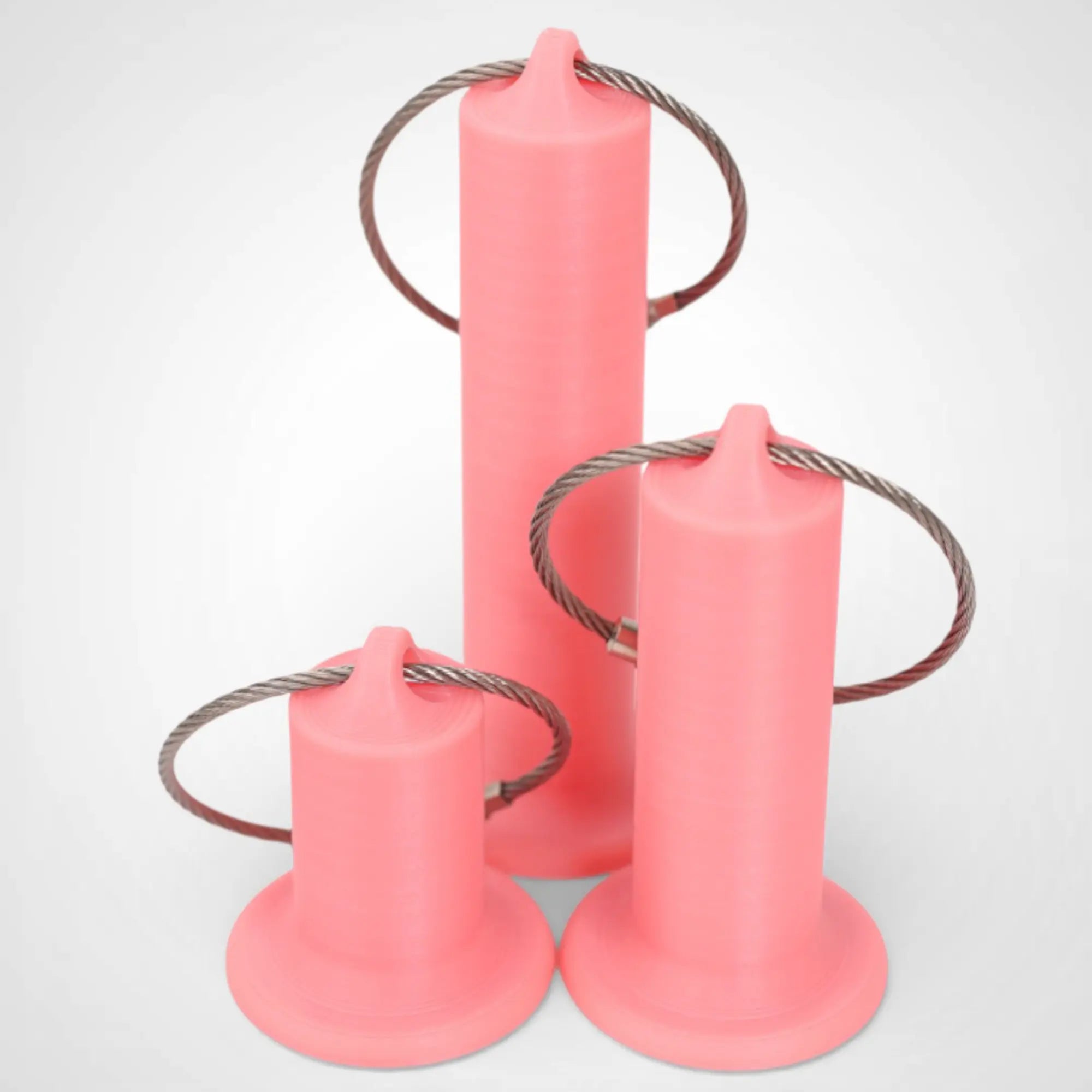Pink Glow Orange roll holders made with polylactic acid, created using additive manufacturing for holding tape and bandage rolls. In three sizes, 1-inch, 2-inch, and 3-inch. With a steel cable keyring. All three sizes shown on white background.