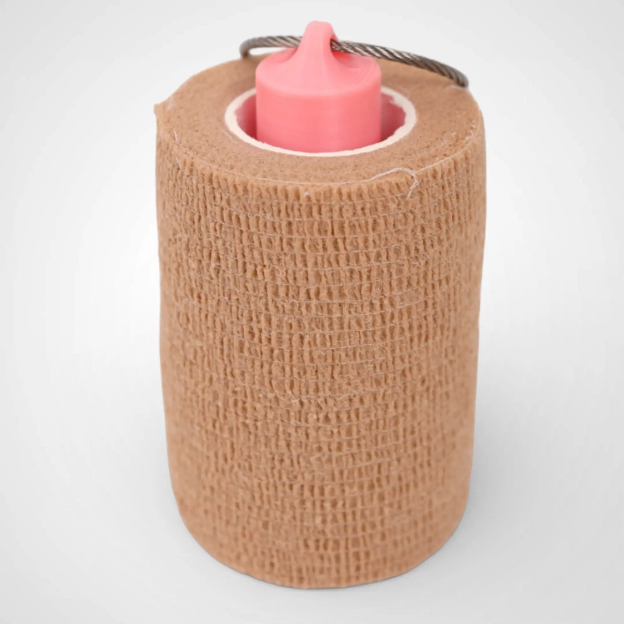 Pink Glow Orange 3-inch roll holder made with polylactic acid, created using additive manufacturing for holding tape and bandage rolls. With a steel cable keyring. Shown with tape on white background.