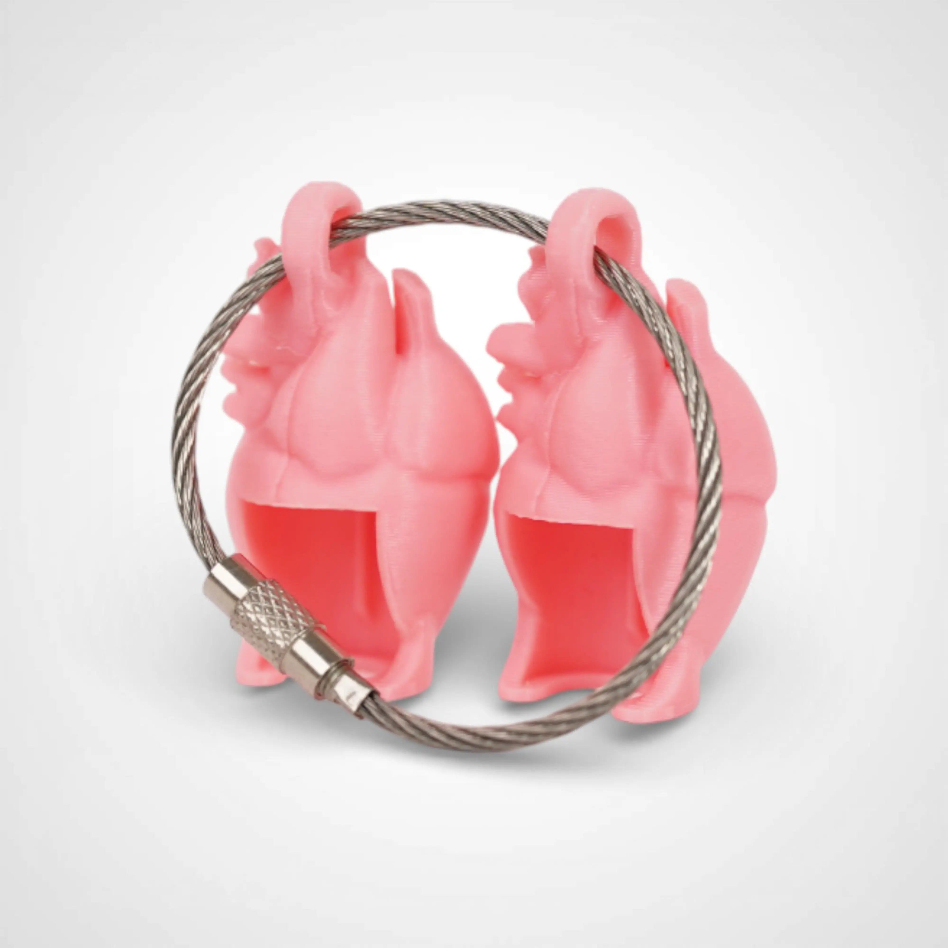 Two pink polylactic acid created using additive manufacturing anatomical heart cap clips on steel cable keyring. Shown on a white background.