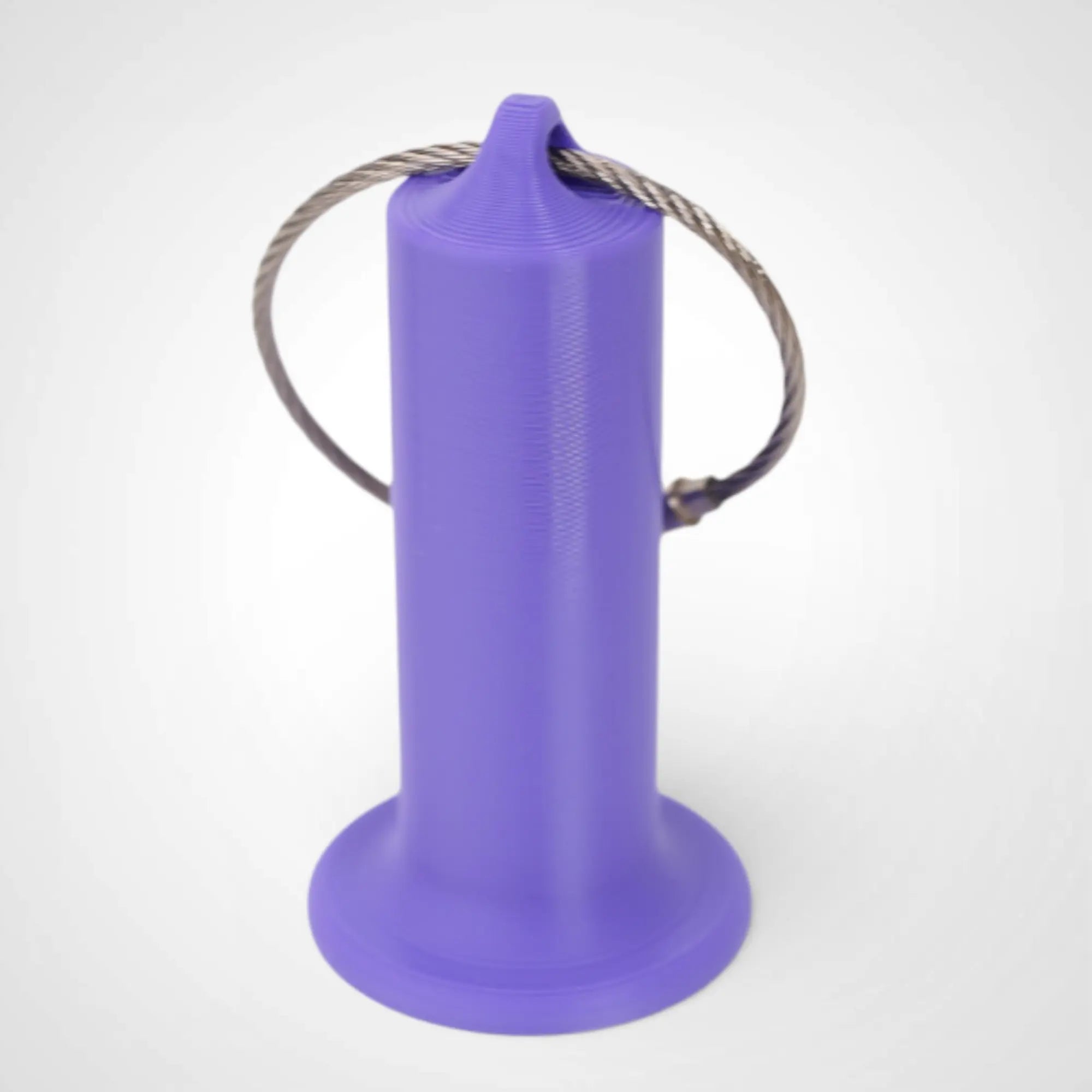 Purple 2-inch roll holder made with polylactic acid, created using additive manufacturing for holding tape and bandage rolls. With a steel cable keyring. Shown on white background.