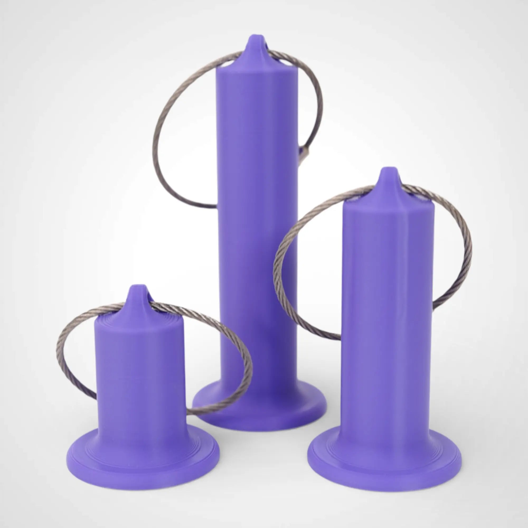Purple roll holders made with polylactic acid, created using additive manufacturing for holding tape and bandage rolls. In three sizes, 1-inch, 2-inch, and 3-inch. With a steel cable keyring. All three sizes shown on white background.