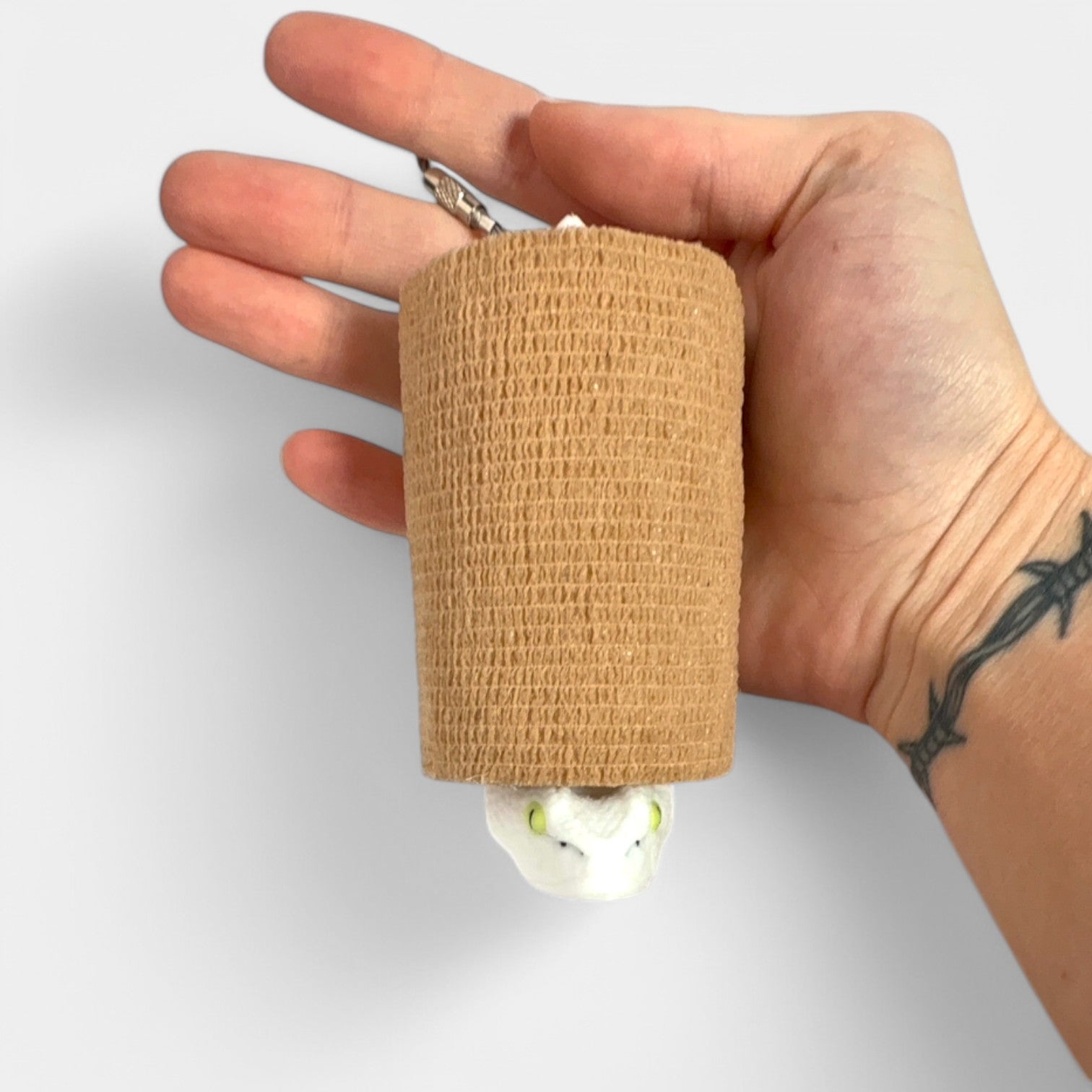 a compact white snake roll holder 3 inches tall to hold and tape and coban for EMS, paramedics, EMT's, nurses, flightmed, vetmed, and athletic trainers