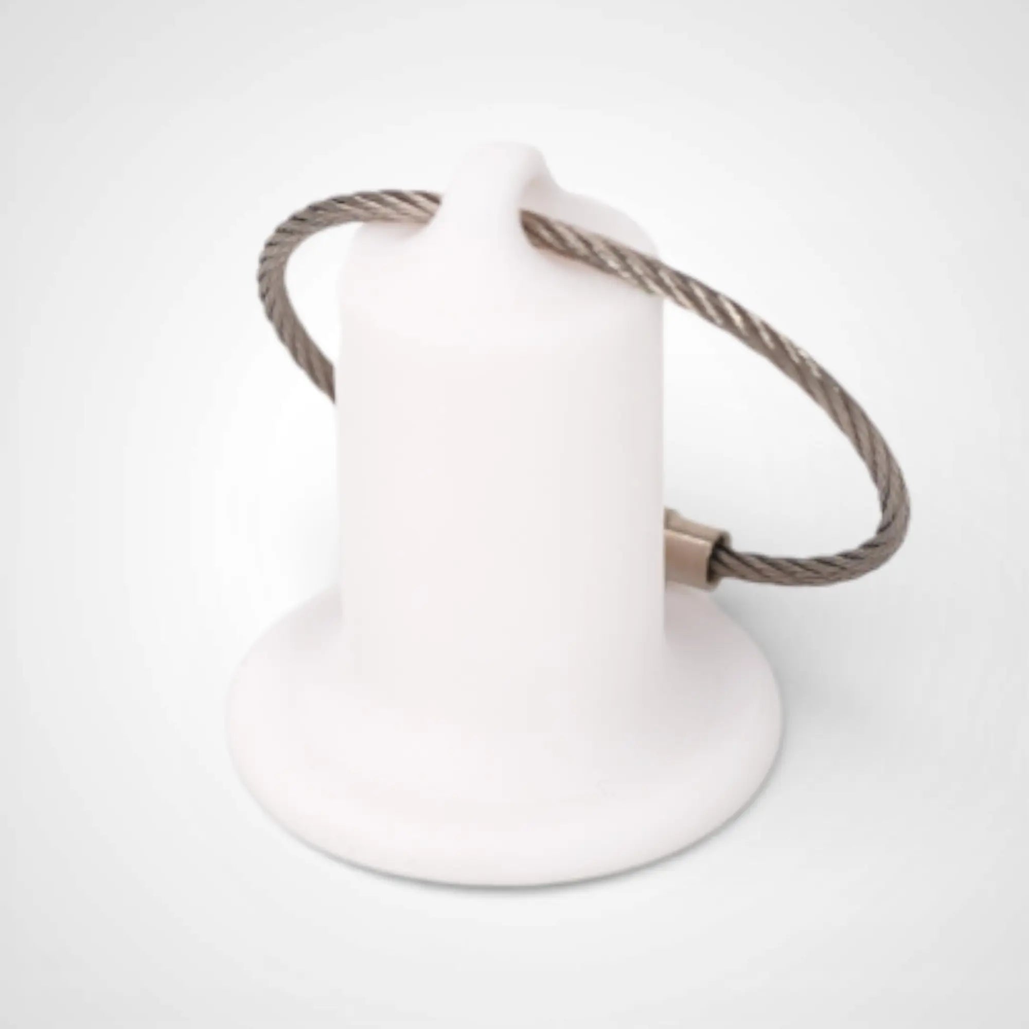 White 1-inch roll holder made with polylactic acid, created using additive manufacturing for holding tape and bandage rolls. With a steel cable keyring. Shown on white background.