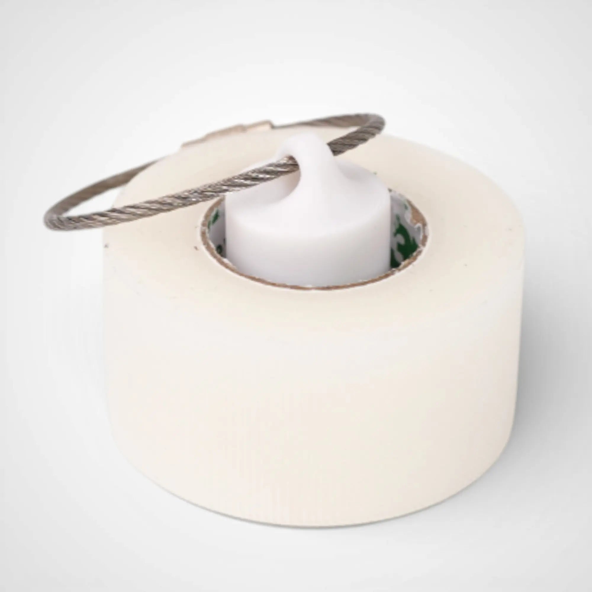 White 1-inch roll holder made with polylactic acid, created using additive manufacturing for holding tape and bandage rolls. With a steel cable keyring. Shown with tape on white background.