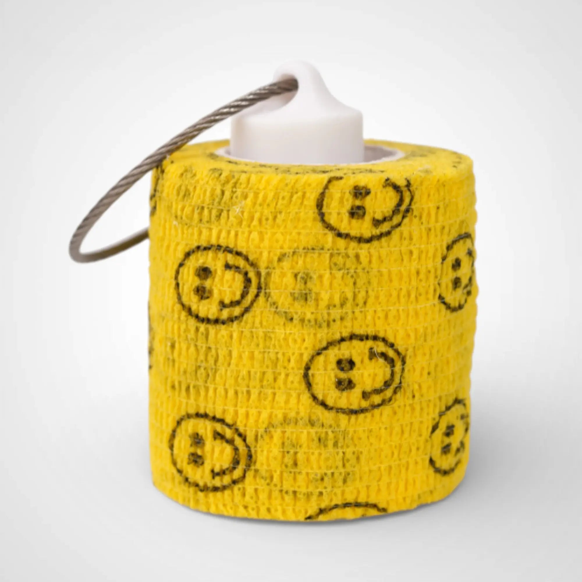 White 2-inch roll holder made with polylactic acid, created using additive manufacturing for holding tape and bandage rolls. With a steel cable keyring. Shown with tape on white background.