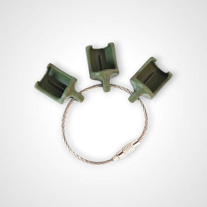 Three army green polylactic acid created using additive manufacturing classic cap clips on steel cable keyring. Shown on a white background.