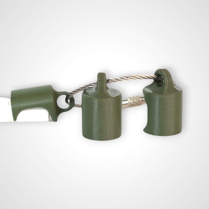 Three army green polylactic acid created using additive manufacturing classic cap clips on steel cable keyring. Featured attached to a syringe. Shown on a white background.