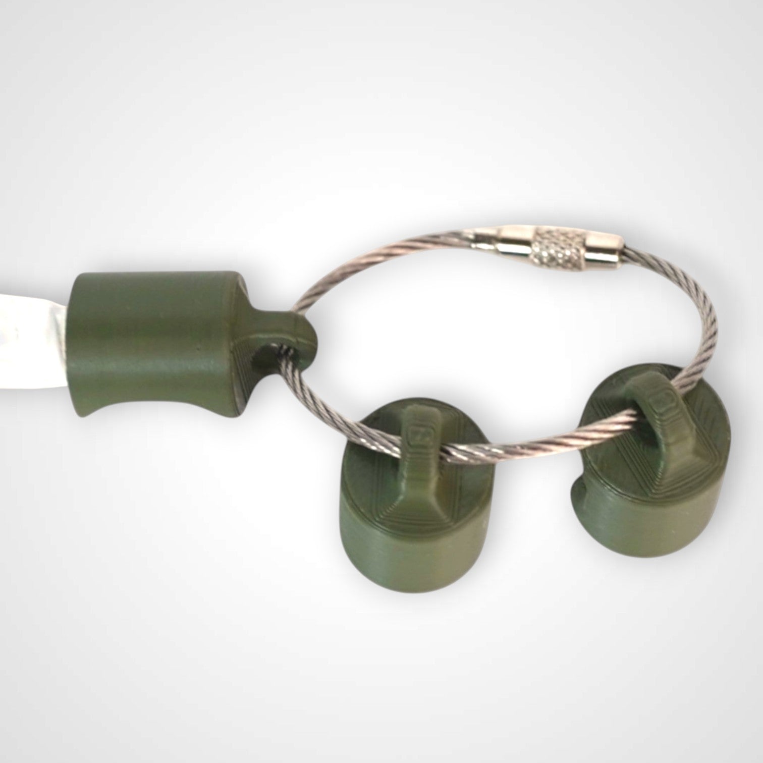 Three army green polylactic acid created using additive manufacturing classic cap clips on steel cable keyring. Shown on a white background.