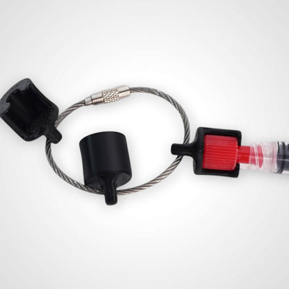 Black polylactic acid created using additive manufacturing B-Braun cap clip on steel cable keyring. Featured attached to a syringe. Shown on white background.