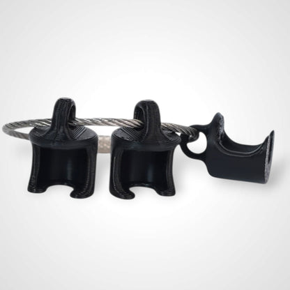 Black polylactic acid created using additive manufacturing B-Braun cap clip on steel cable keyring. Shown on white background.
