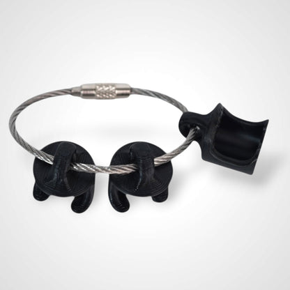 Black polylactic acid created using additive manufacturing B-Braun cap clip on steel cable keyring. Shown on white background.