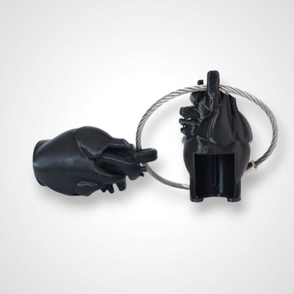 Two black polylactic acid created using additive manufacturing anatomical heart cap clips on steel cable keyring. Shown on a white background.