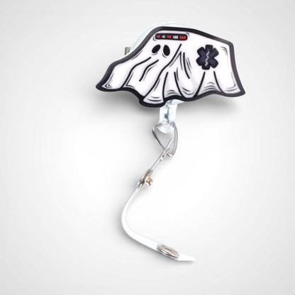 Ghost ambulance badge reel. On a swivel-alligator clip that rotates 360° with a nylon retractable string. Shown on a white background.