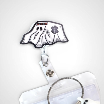 Ghost ambulance badge reel. On a swivel-alligator clip that rotates 360° with a nylon retractable string. Shown on a white background.