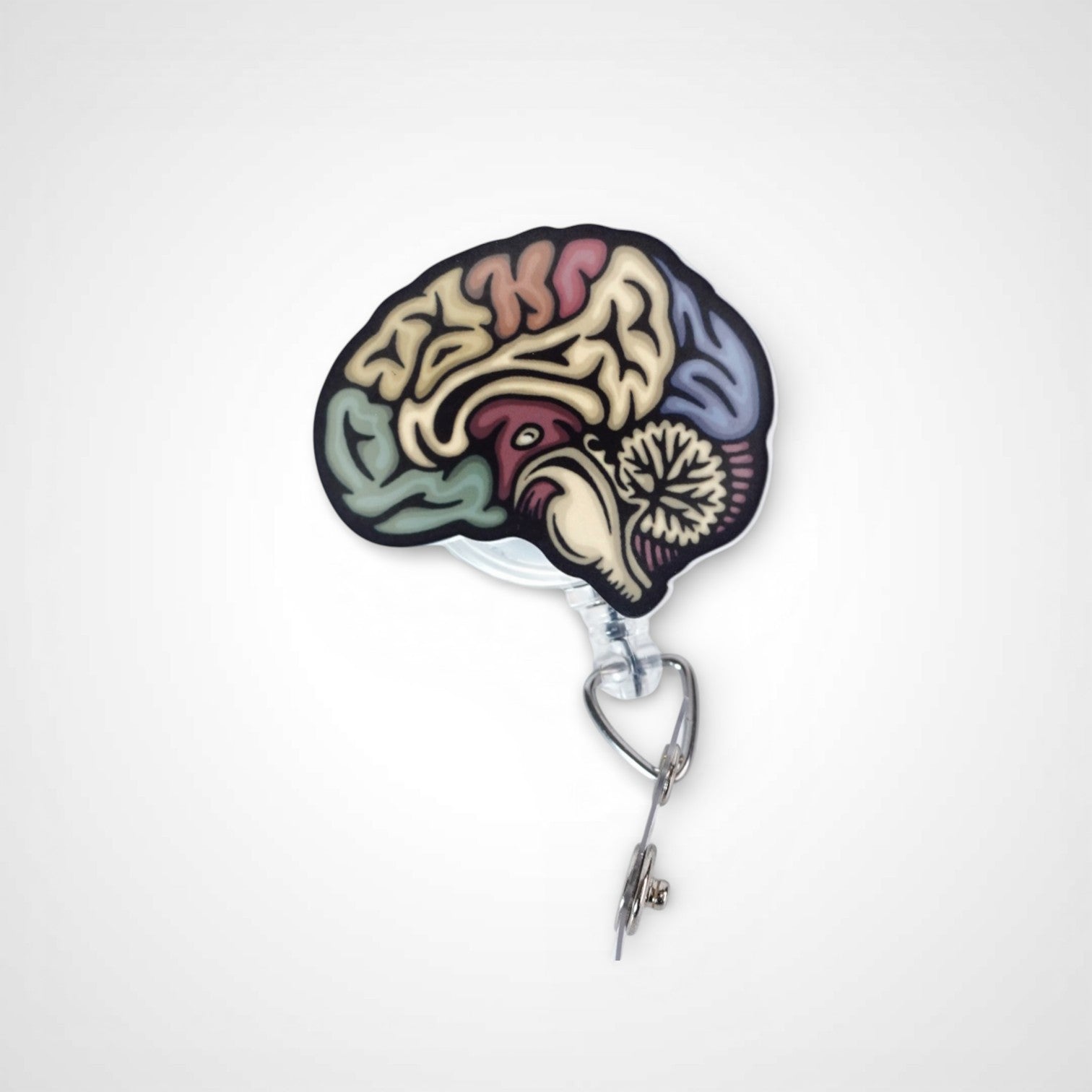 Sagittal Brain badge reel. On a swivel-alligator clip that rotates 360° with a nylon retractable string. Shown on a white background.