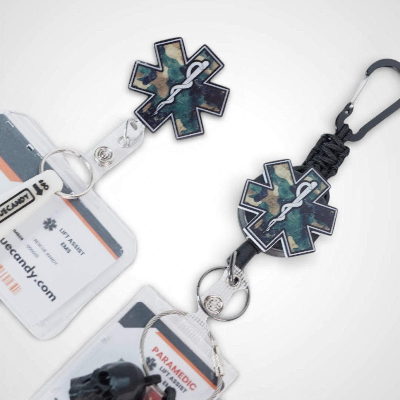 Camo Star badge reel. On a carabiner with a steel retractable cable next to a swivel-alligator clip that rotates 360° with a nylon retractable string. Shown on a white background. 