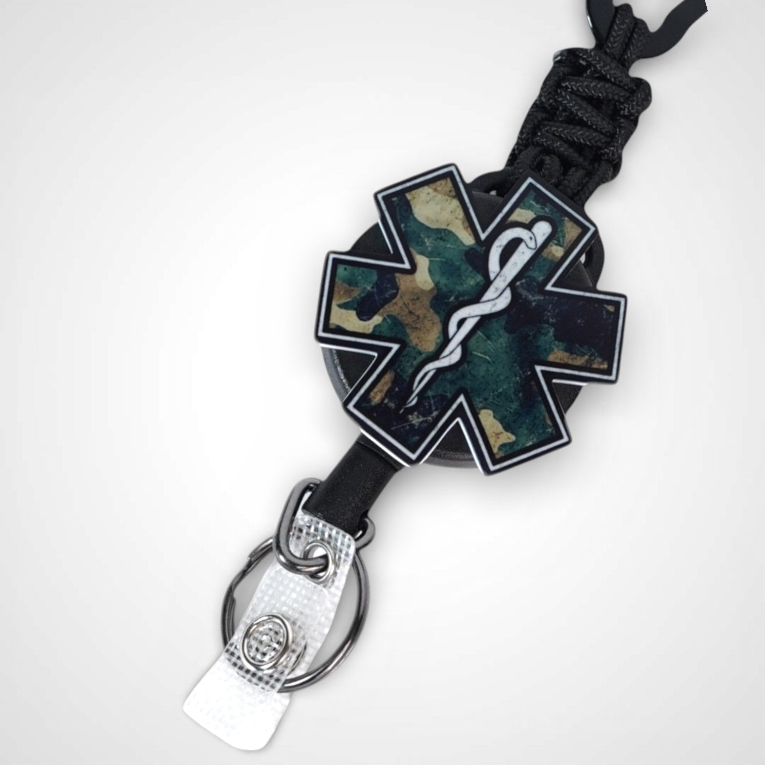 Camo Star badge reel. On a carabiner with a steel retractable cable. Shown on a white background.