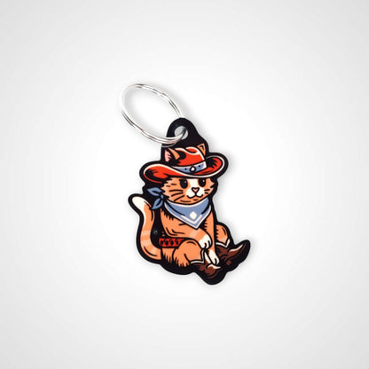 Cowboy cat cast acrylic keychain with double coil keyring. Shown on white background.