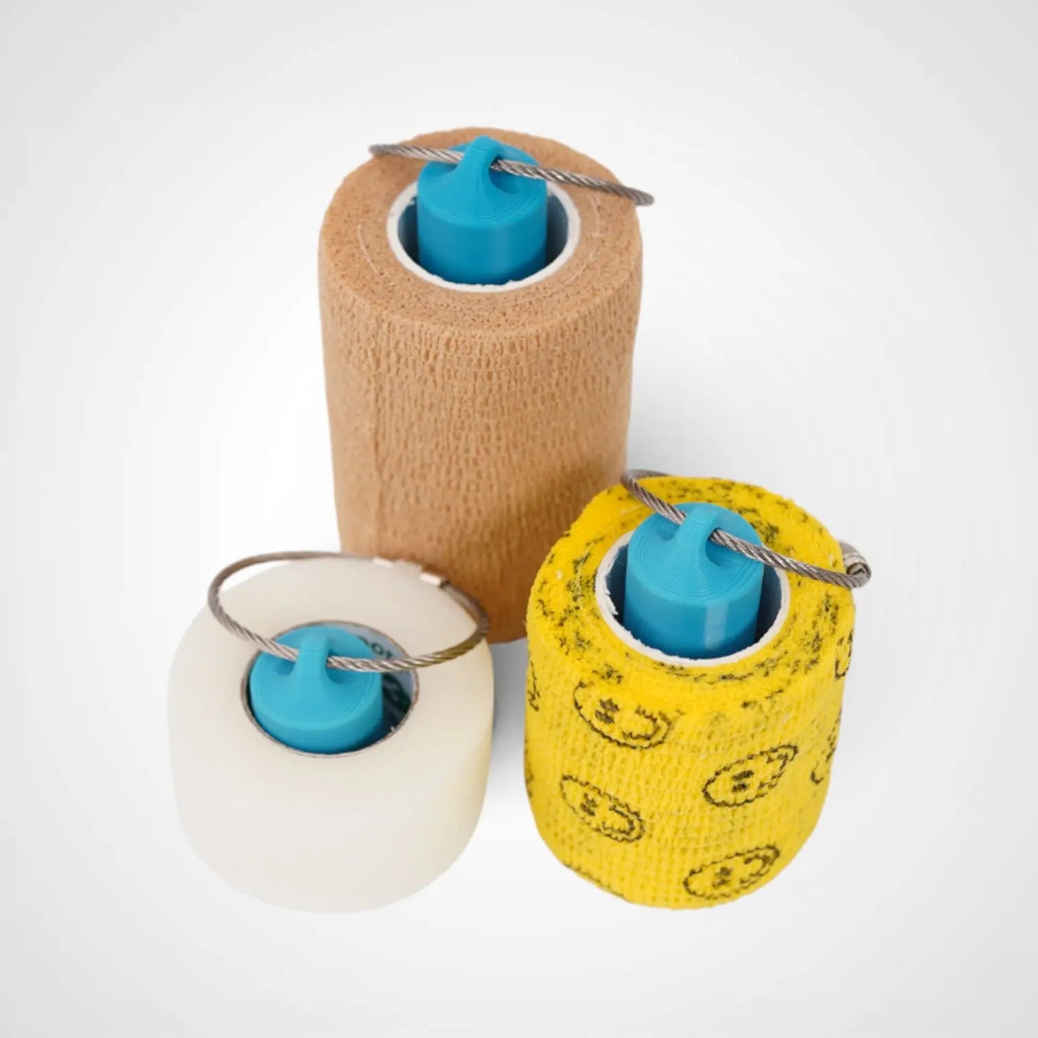 a compact utility keychain called a blue roll holder 3 inches tall, 2 inches tall, 1 inches tall to hold and tape transpore tape cohesive bandage coban and bangade rolls for EMS, paramedics, EMT's, nurses, flightmed, vetmed, and athletic trainers