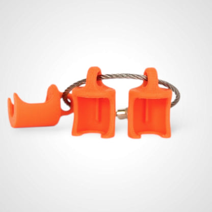 Three orange polylactic acid created using additive manufacturing classic cap clips on steel cable keyring. Shown on a white background.