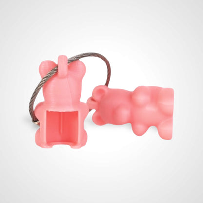 Two pink polylactic acid created using additive manufacturing gummy bear cap clips on steel cable keyring. Shown on a white background.