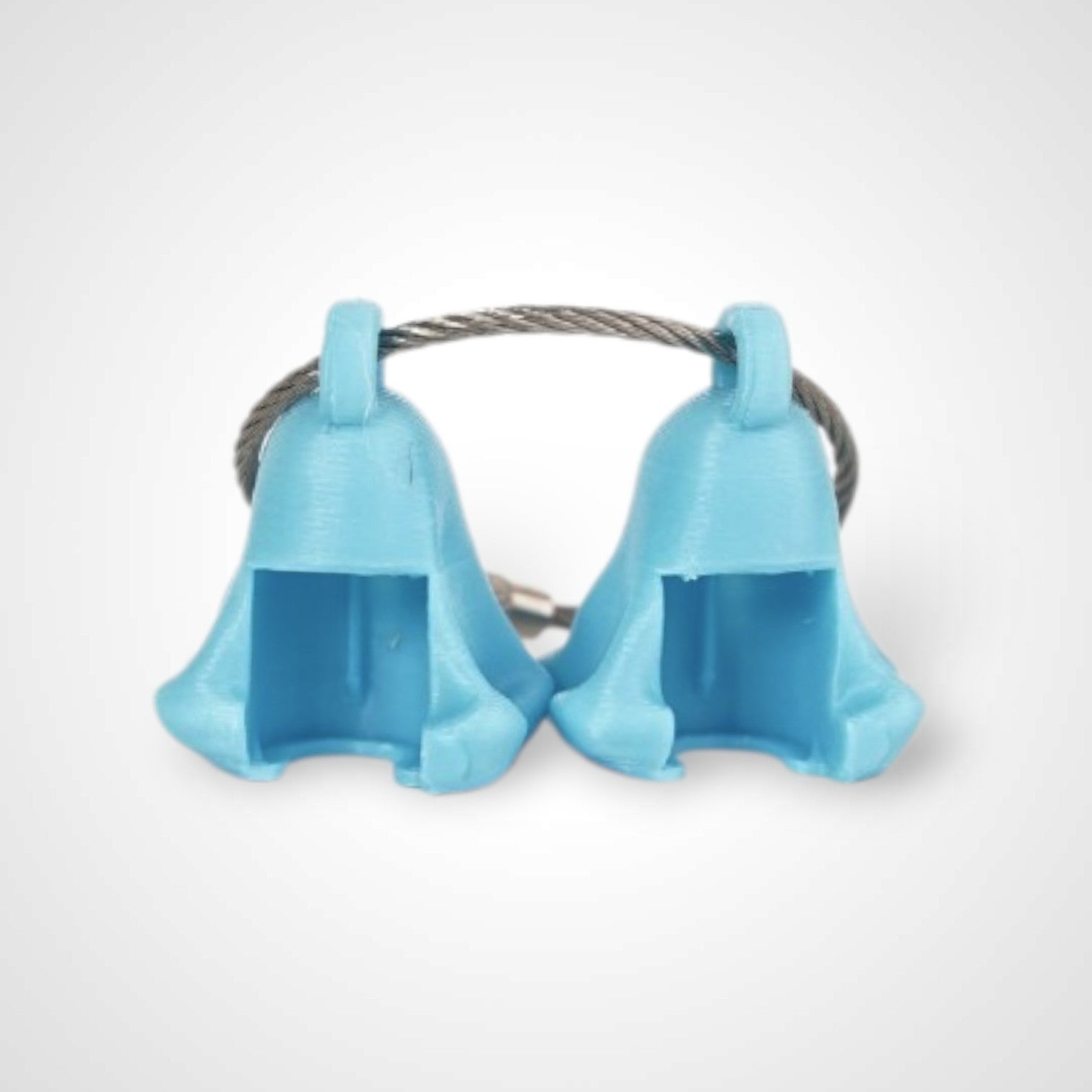Two blue polylactic acid created using additive manufacturing ghost cap clips on steel cable keyring. Shown on a white background.