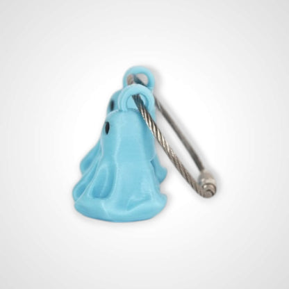Two blue polylactic acid created using additive manufacturing ghost cap clips on steel cable keyring. Shown on a white background.