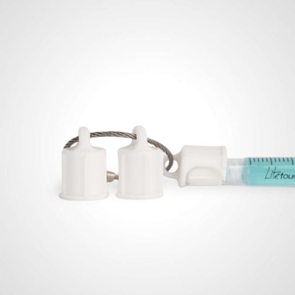Three white polylactic acid created using additive manufacturing faux flush cap clip on steel cable keyring. Featured attached to a syringe. Shown on a white background.