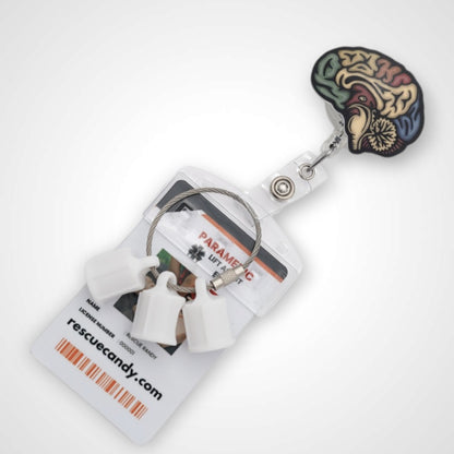 Sagittal Brain badge reel. On a swivel-alligator clip that rotates 360° with a nylon retractable string. Shown on a white background.