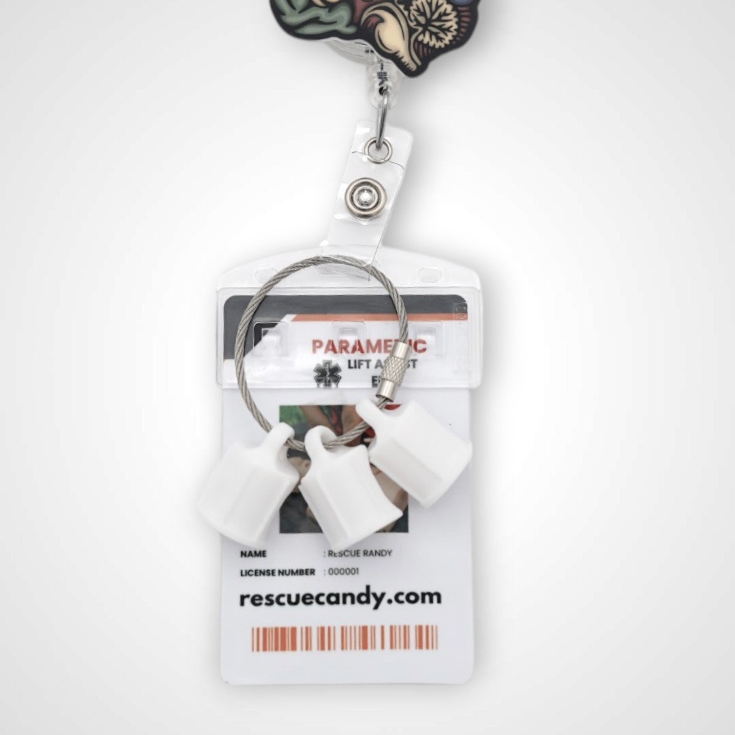 Three white polylactic acid created using additive manufacturing faux flush cap clip on steel cable keyring. Featured attached to a badge. Shown on a white background.
