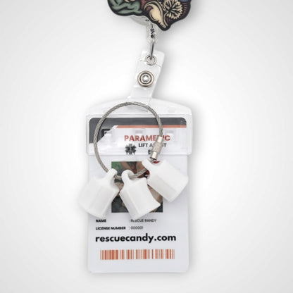 Three white polylactic acid created using additive manufacturing faux flush cap clip on steel cable keyring. Featured attached to a badge. Shown on a white background.