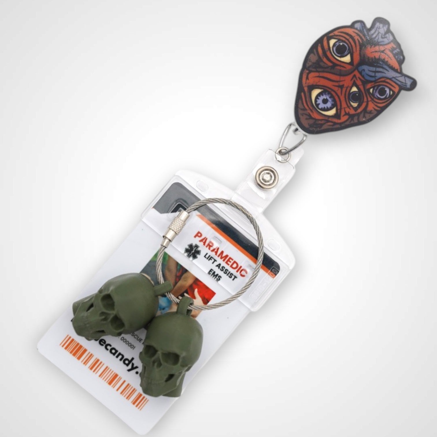 Oculus Cordis badge reel. On a swivel-alligator clip that rotates 360° with a nylon retractable string. Shown on a white background.