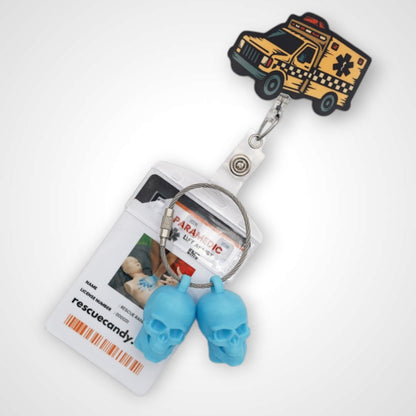 Taxi badge reel. On a swivel-alligator clip that rotates 360° with a nylon retractable string. Shown on a white background.