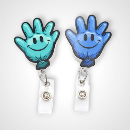 Teal and blue happy glove partner set badge reel. On a swivel-alligator clip that rotates 360° with a nylon retractable string. Shown on a white background.