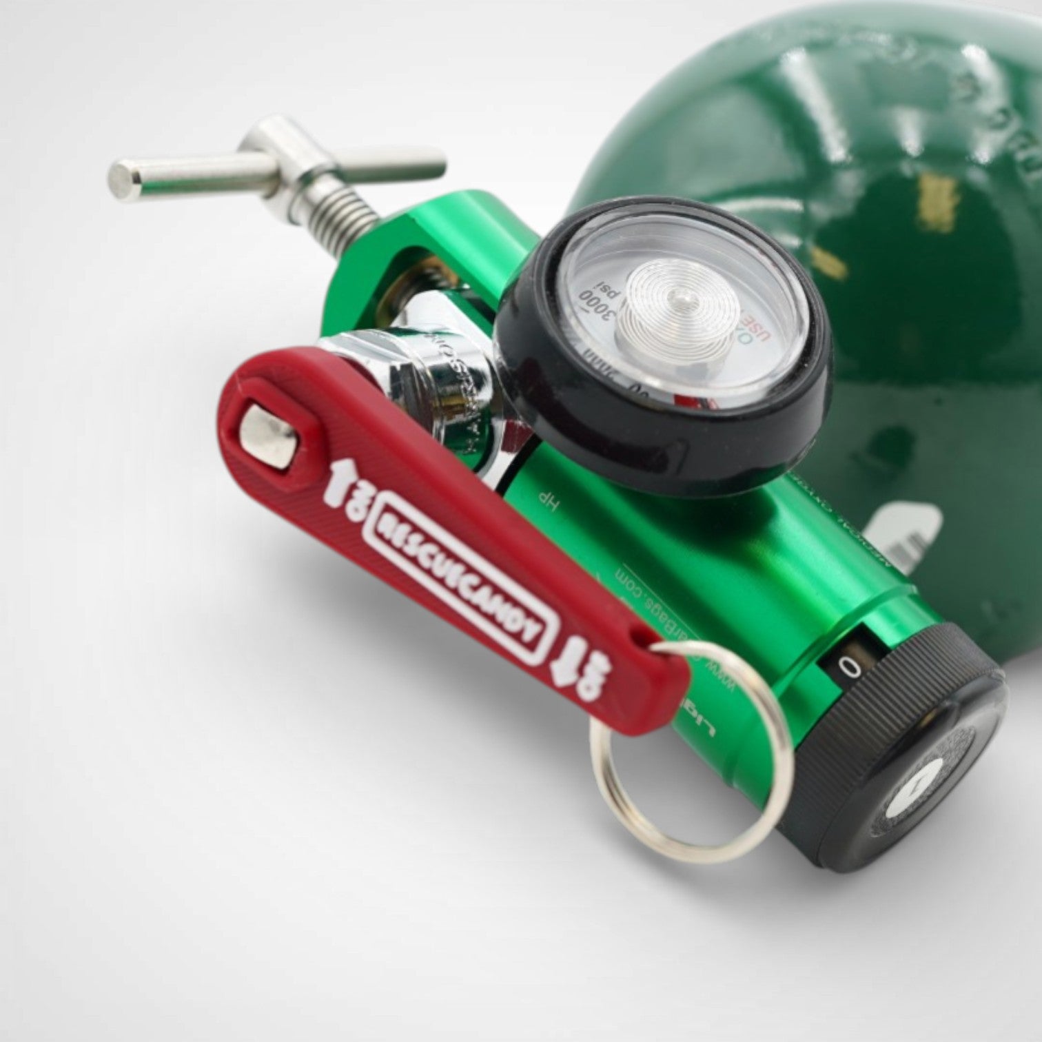 Mini red Oxygen Wrench. Made to fit CGA-870 valves. Shown attached to oxygen bottle on white background.