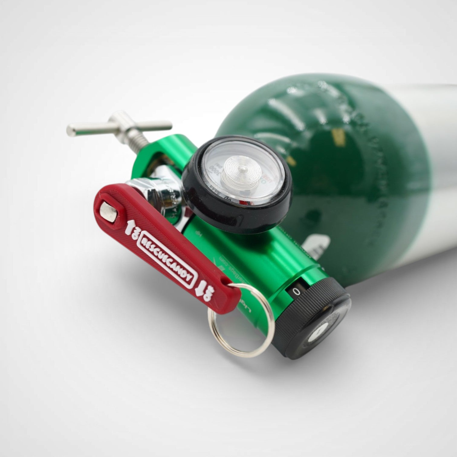 Mini red Oxygen Wrench. Made to fit CGA-870 valves. Shown attached to oxygen bottle on white background.