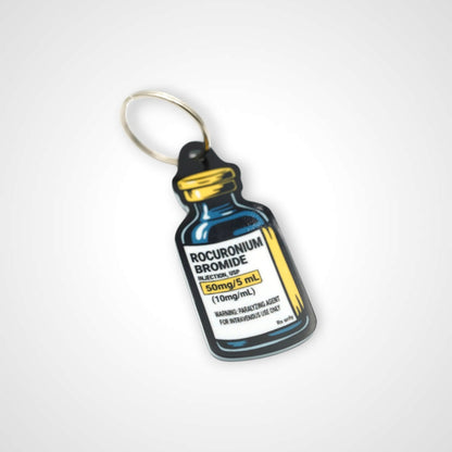 Rocuronium vial cast acrylic keychain with double coil keyring. Shown on white background.