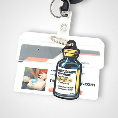 Rocuronium vial cast acrylic keychain with double coil keyring. Shown on badge.