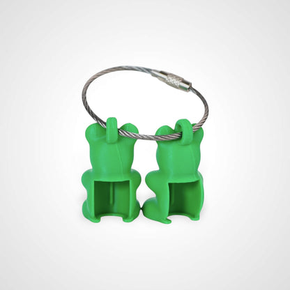 Two green polylactic acid created using additive manufacturing gummy bear cap clips on steel cable keyring. Shown on a white background.