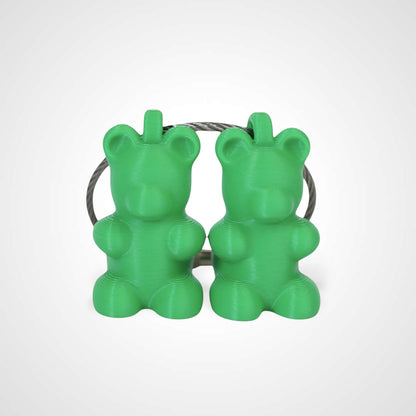 Two green polylactic acid created using additive manufacturing gummy bear cap clips on steel cable keyring. Shown on a white background.