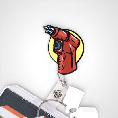 IO Drill badge reel. On a swivel-alligator clip that rotates 360° with a nylon retractable string. Shown on a white background.