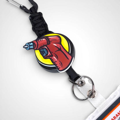 IO Drill badge reel. On a carabiner with a steel retractable cable. Shown on a white background.