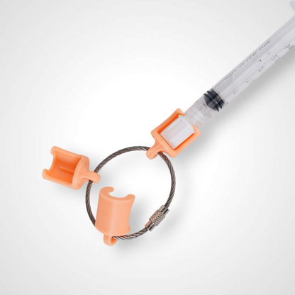 Three orange polylactic acid created using additive manufacturing classic cap clips on steel cable keyring. Featured attached to a syringe. Shown on a white background.