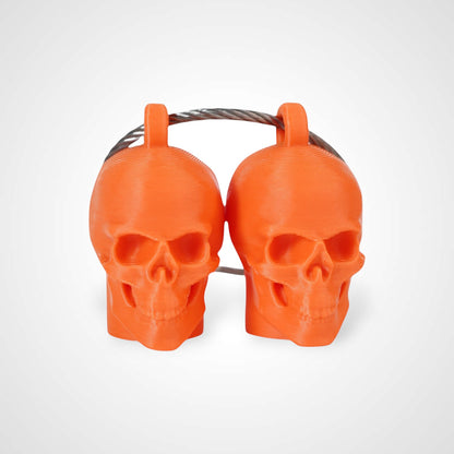 Two orange polylactic acid created using additive manufacturing skull cap clips on steel cable keyring. Shown on a white background.