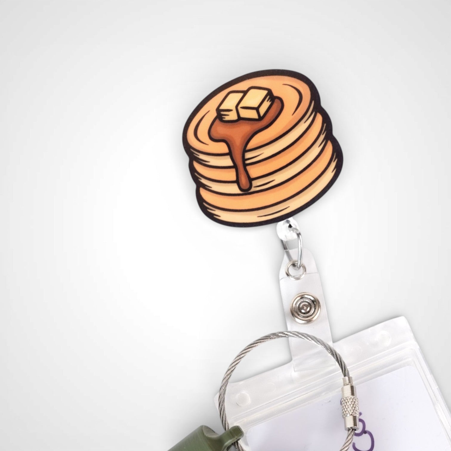 Pancake badge reel. On a swivel-alligator clip that rotates 360° with a nylon retractable string. Shown on a white background.